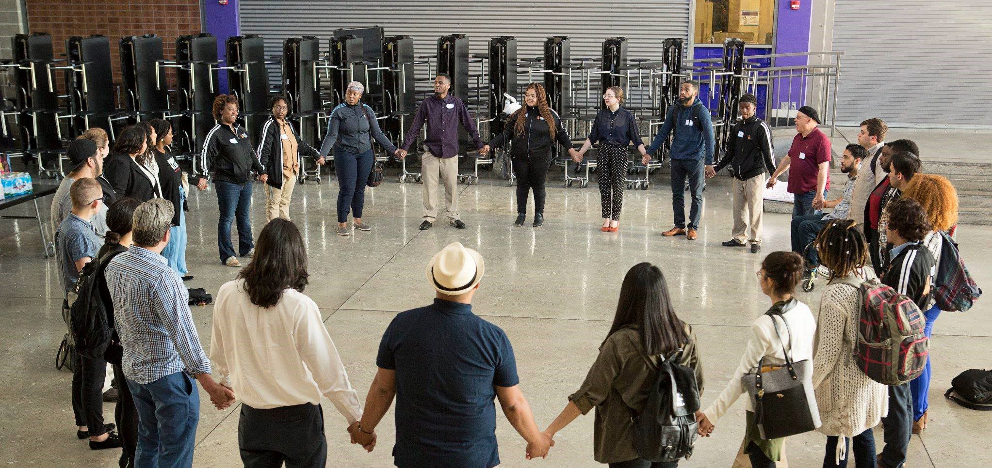 Public Allies WI cohort event, large group holding hands in a circle